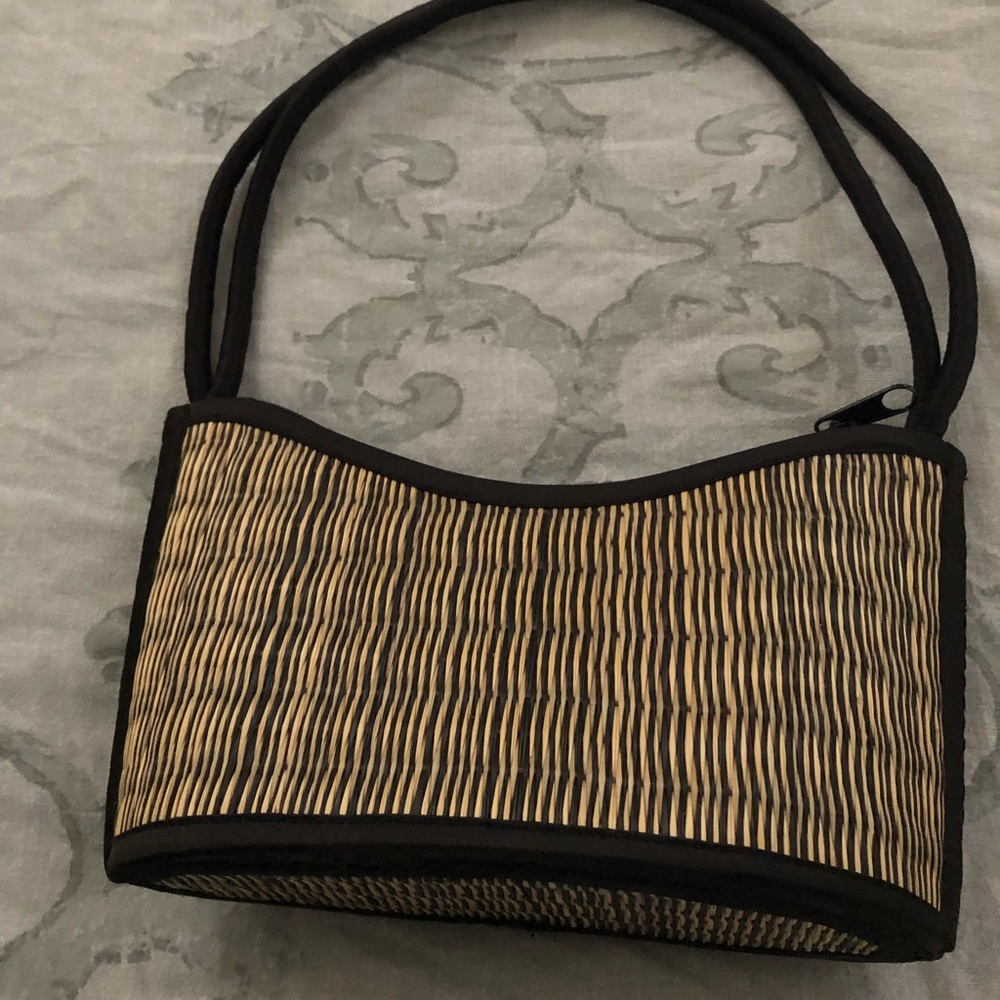 Bamboo purse with black handles.